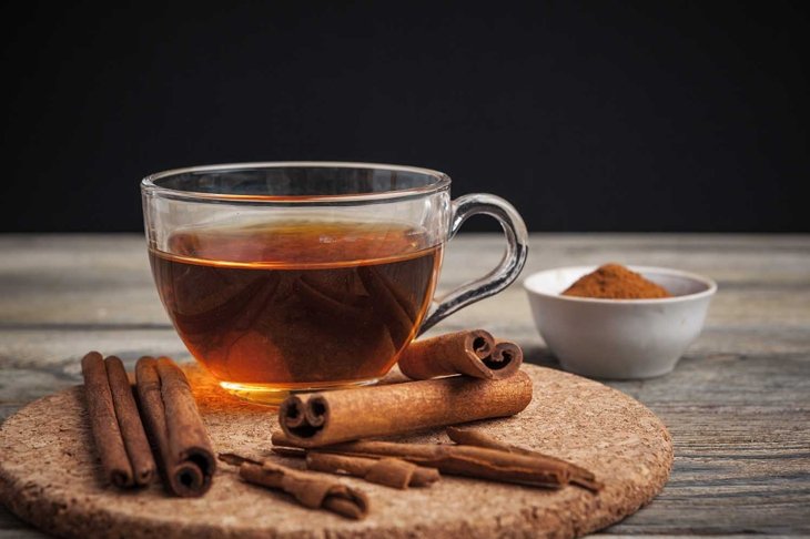 aromatic hot cinnamon tea on wooden table