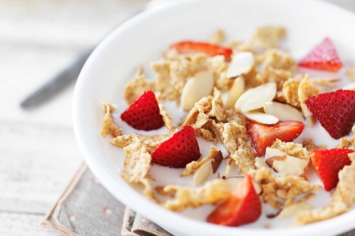 bowl of cereal with strawberries and almonds